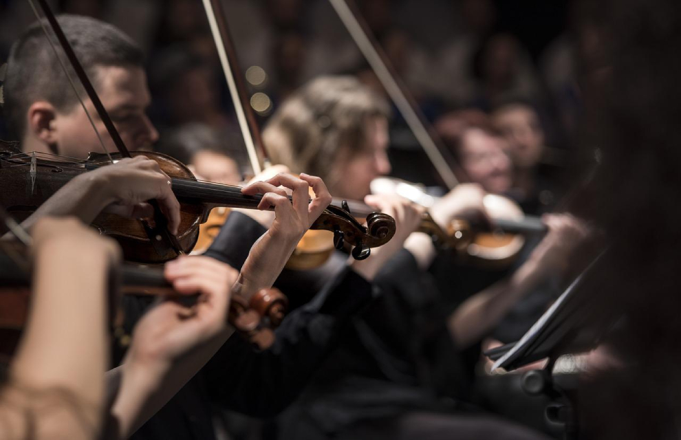 People performing with violins on stage